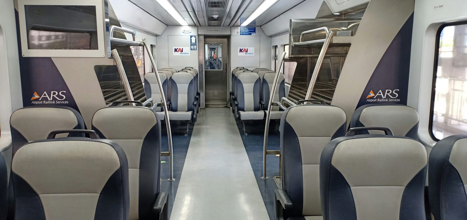 an empty train car with blue and white seats